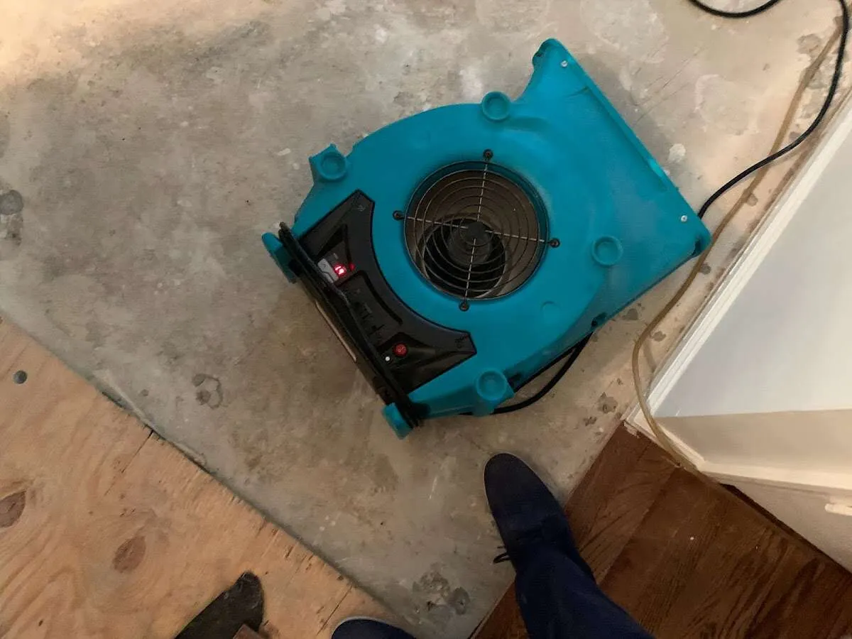 Air mover drying subfloor during Commercial Water Damage Restoration in Groton